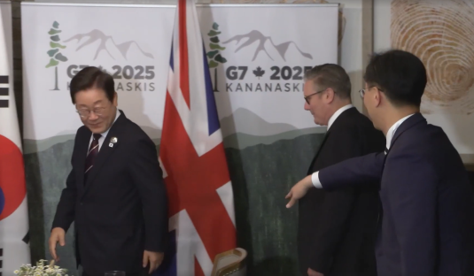 Three men in suits at a G7 2025 Kananaskis event.