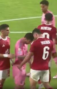 Lionel Messi appearing to headbutt an opponent during a soccer match.