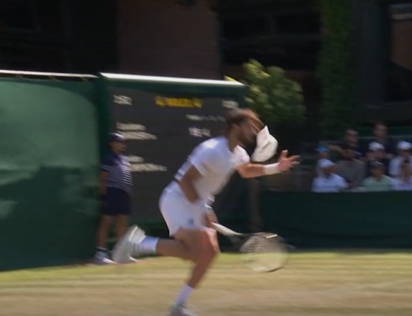 Tennis player running on court.