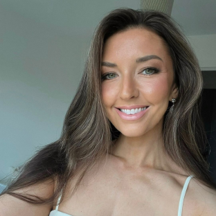 Portrait of a smiling woman with long brown hair.