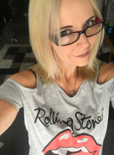 Selfie of a woman wearing a Rolling Stones t-shirt.