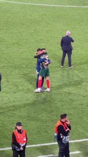 Cristiano Ronaldo hugging a teammate after a penalty shootout.