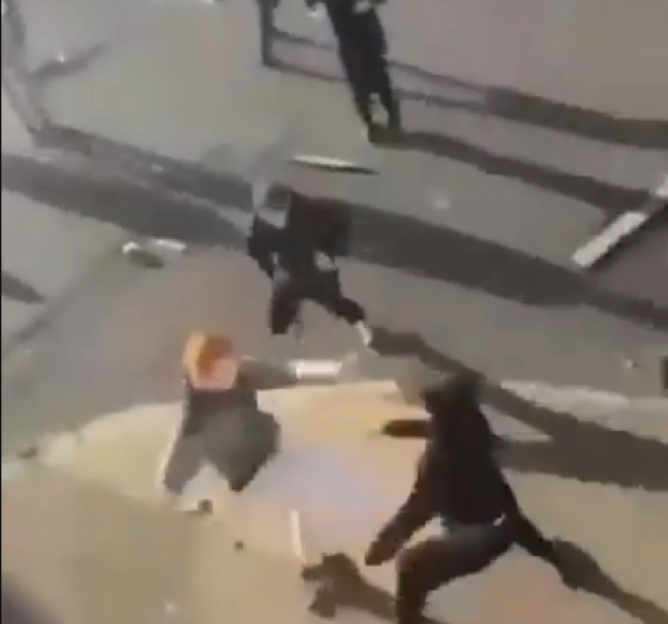 People fighting in the street.
