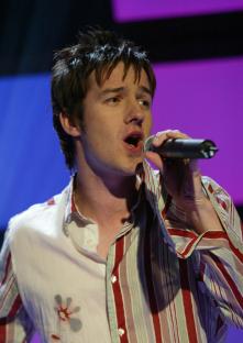 Alistair Griffin singing into a microphone.