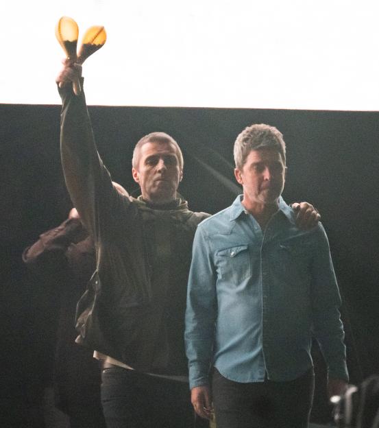 Liam and Noel Gallagher of Oasis at a concert.