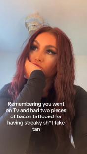 Woman with long brown hair reacting to having received bacon tattoos on a TV show.