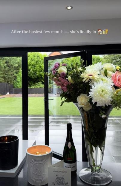 Flowers, candles, and champagne in a new home.