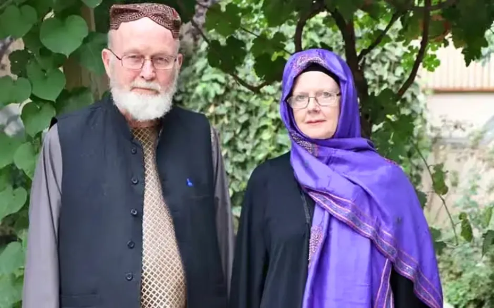 Portrait of an older man and woman standing together.
