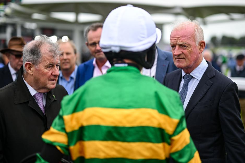 JP McManus and Willie Mullins at a horse race.