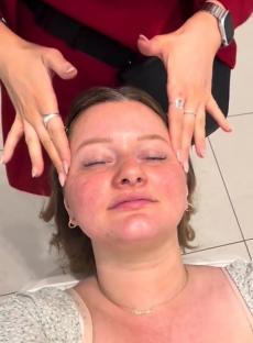 Woman receiving a facial massage.