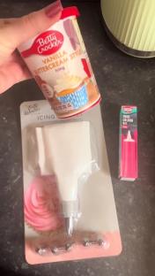 Vanilla buttercream icing, piping tool, and pink food coloring gel.