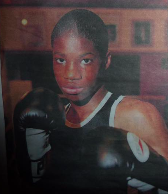Portrait of a young boxer wearing boxing gloves.