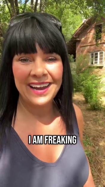 Woman standing outside a house, saying