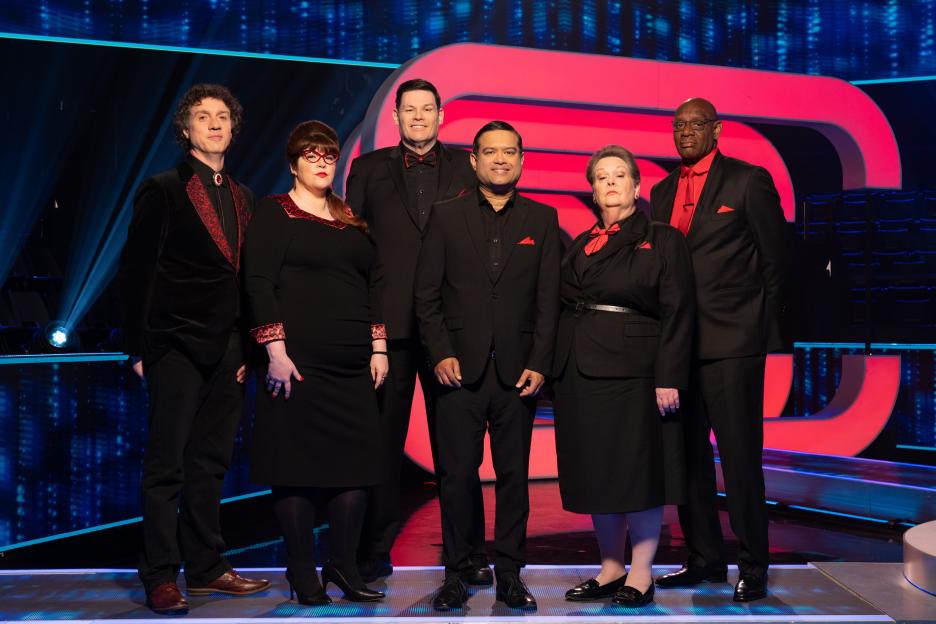 The Chasers from the British TV show *Beat The Chasers*: Darragh Ennis, Jenny Ryan, Mark Labbett, Paul Sinha, Anne Hegerty, and Shaun Wallace.