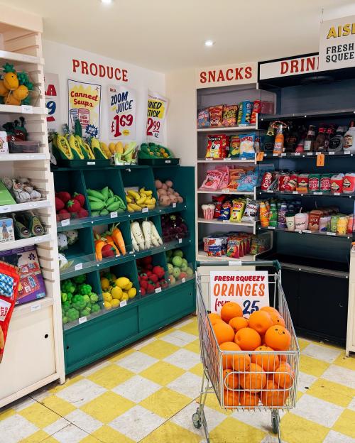 A grocery store display of plush fruit and snacks for dogs.