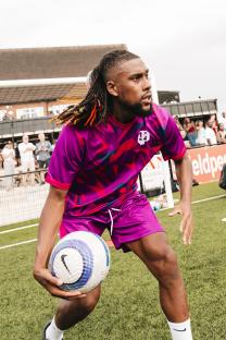Alex Iwobi holding a soccer ball.