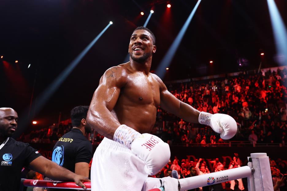 Anthony Joshua celebrating a boxing victory.