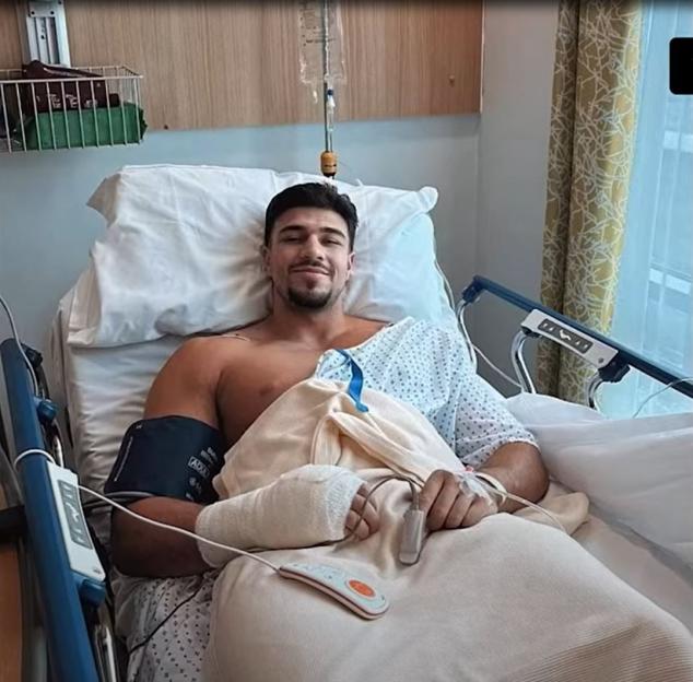 Tommy Fury in a hospital bed with a bandaged hand.