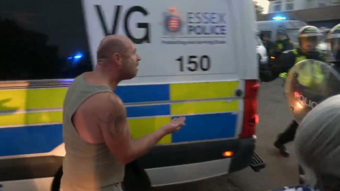 Man confronting riot police.