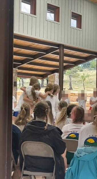 Campers and staff being evacuated after floods.