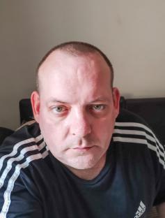 Close-up photo of Paul Davis, an AI scam victim.