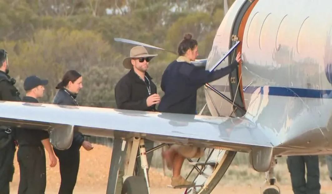 People boarding a small airplane.