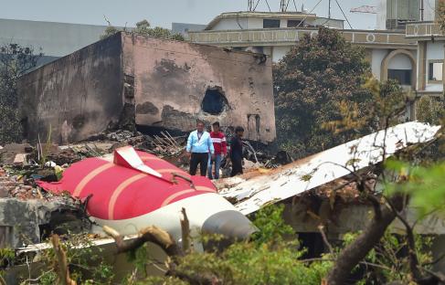 Debris from a plane crash site with investigators.