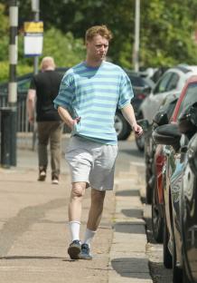 Jamie Borthwick walking down a street.