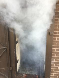 Smoke billowing from a fire safety feature.