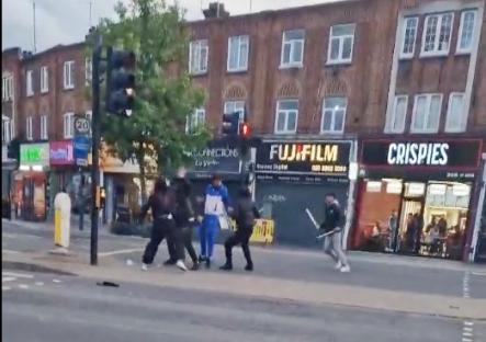 Street brawl between people wielding bats.