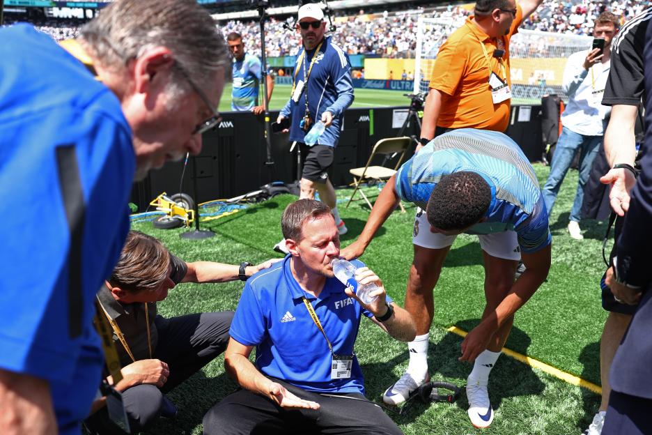 Kylian Mbappé assists a volunteer who was hit by a ball during a soccer match warm-up.