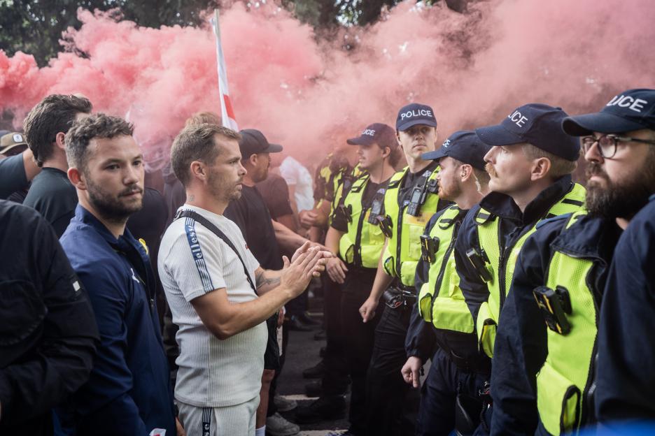 Police officers separating anti-immigration protestors and counter-protestors.