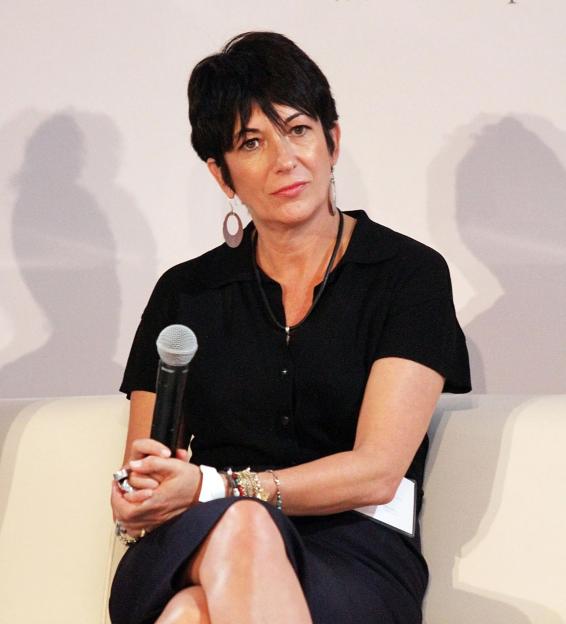a woman sits on a couch holding a microphone in front of a sign that says women inspire