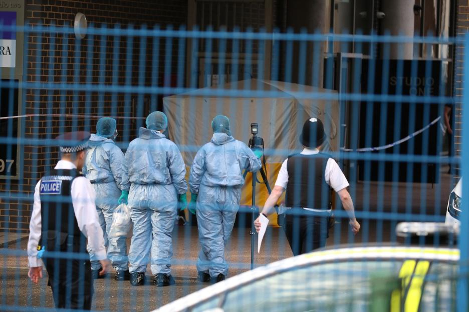 Forensic officers at a murder scene.