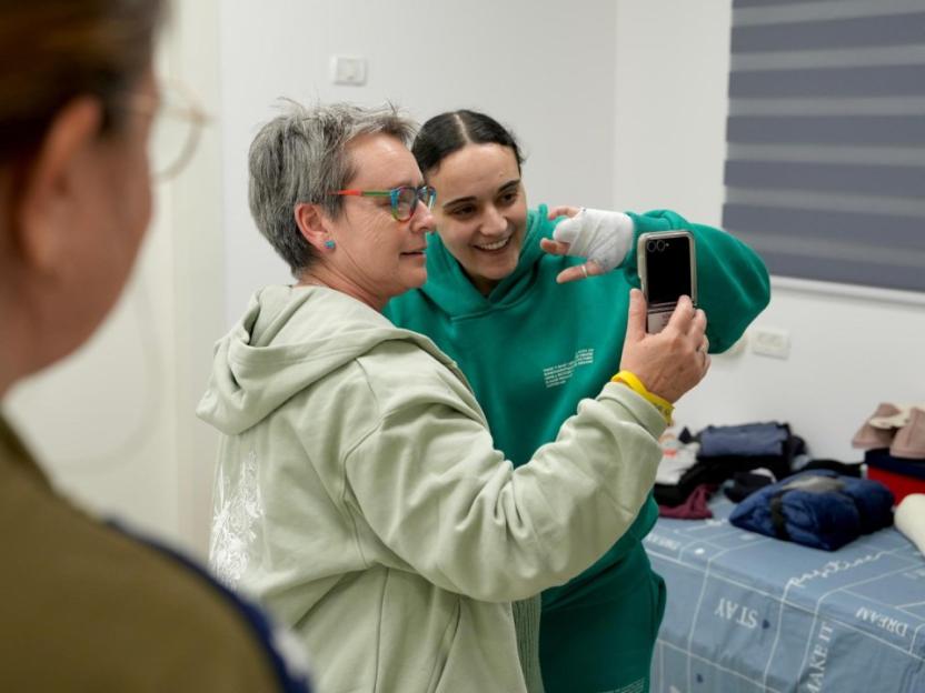 Two women taking a selfie. One woman has a bandaged hand.