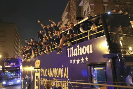 Real Oviedo players celebrating on a bus after winning promotion to La Liga.
