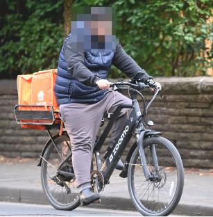 Person delivering food on an electric bike.