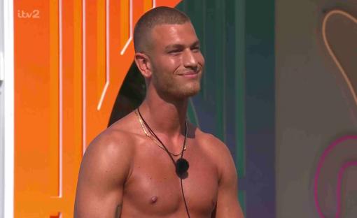 Shirtless man smiling.