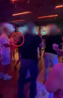 People dancing in a dimly lit nightclub.