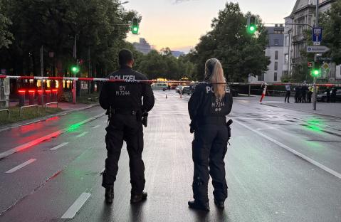 Two police officers guarding a crime scene.
