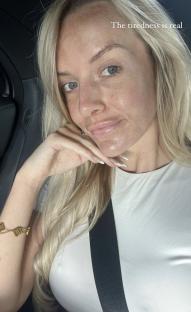 Close-up selfie of a tired woman in a car.