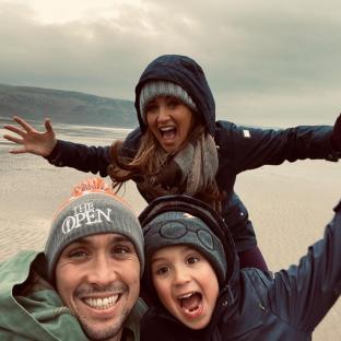 Family selfie on a beach.