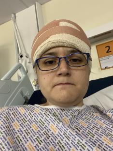 Woman in hospital bed after brain tumour diagnosis.
