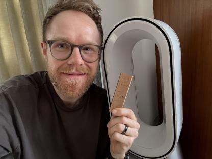 Person holding a Dyson fan remote.