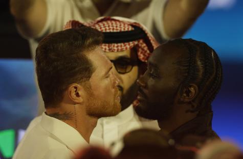 Canelo Alvarez and Terence Crawford face each other at a press conference.