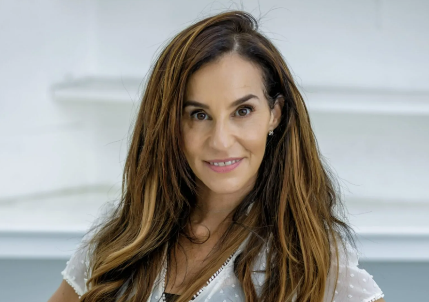 Portrait of a woman with long brown hair.
