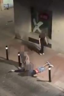 A person being choked by another person on the ground.