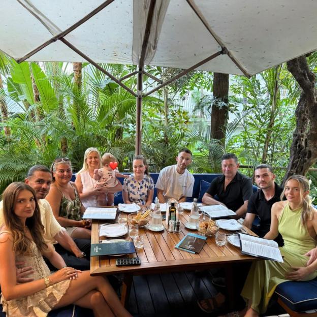Jack Grealish with family and friends at an outdoor restaurant.