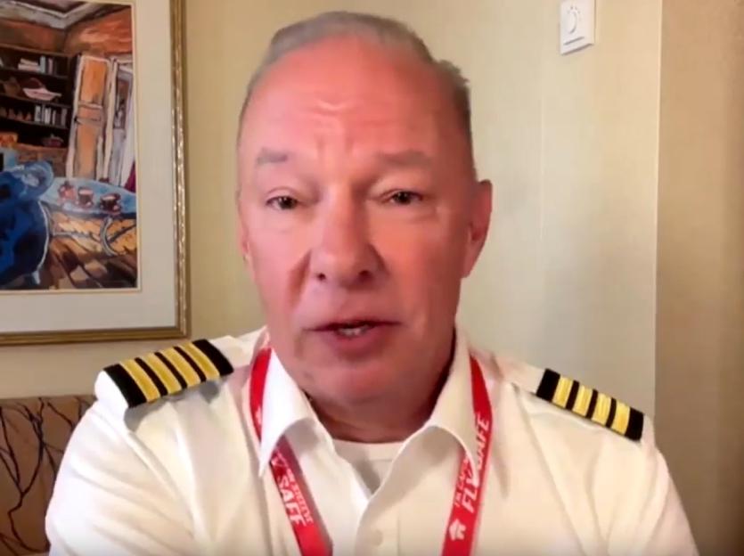 Pilot in uniform speaking.