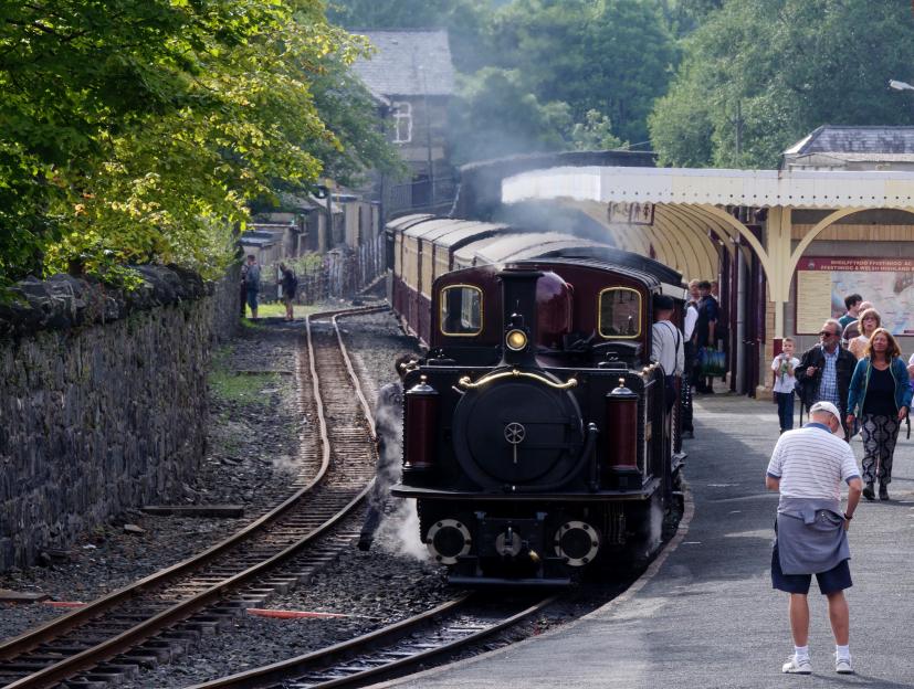 Steam train arriving at a railway station.